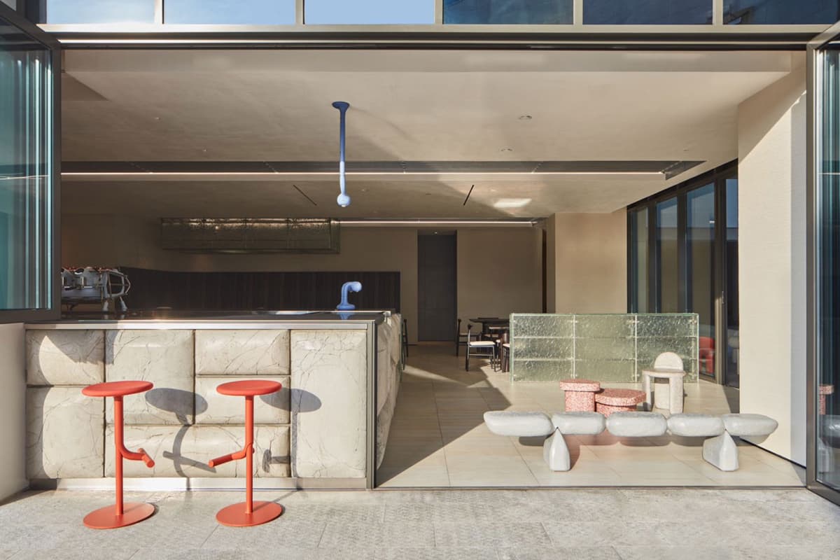 The Lazy Guy Downtown courtyard with red stools and stone counter